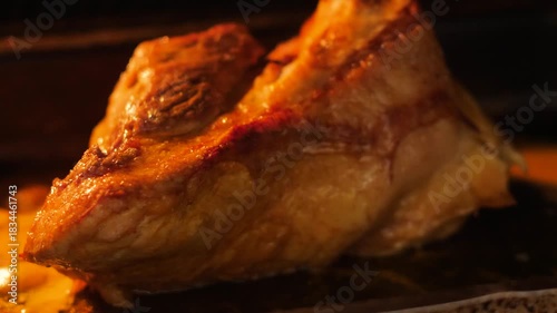 close-up of a piece of meat frying on a baking sheet in the oven, appetizing piece of meat being cooked in the kitchen, meat delicacies preparation