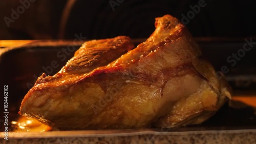 close-up of a piece of meat frying on a baking sheet in the oven, appetizing piece of meat being cooked in the kitchen, meat delicacies preparation