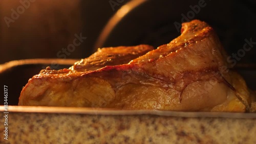 close-up of a piece of meat frying on a baking sheet in the oven, appetizing piece of meat being cooked in the kitchen, meat delicacies preparation