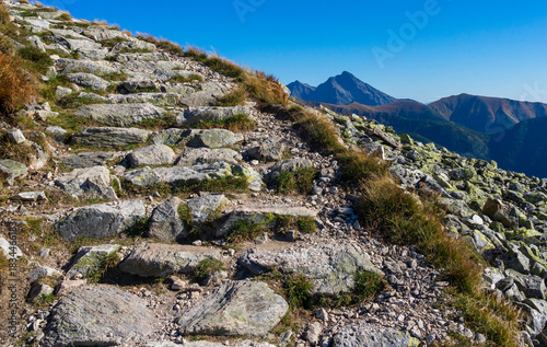 Rocky mountain trail in the Tatra Mountains with a view of Krivan.