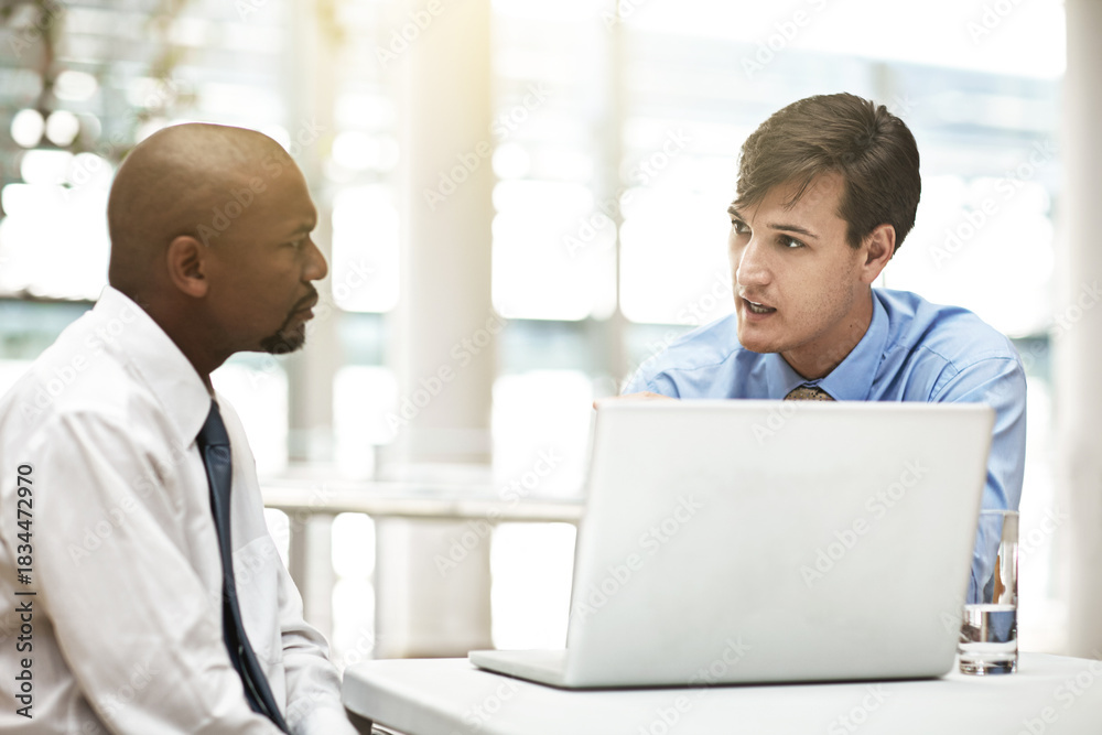 Obraz premium Business, men and laptop with serious meeting for performance review, concern and update. HR manager, tech and employee with discussion in office for career evaluation, negative feedback and advice