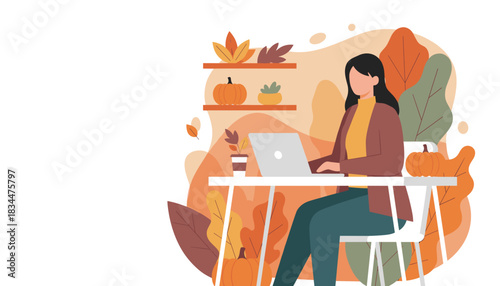 Woman working on laptop in cozy home office decorated for autumn with pumpkins and leaves