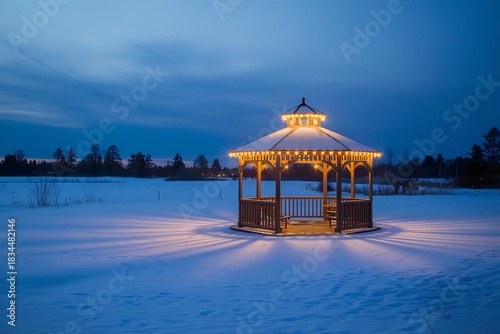 Illuminated Gazebo in Winter Landscape Creates a Serene and Magical Nighttime Scene