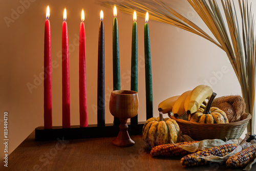 Kwanzaa Table Setting. A festive Kwanzaa display with Kinara, fruits, and vegetables