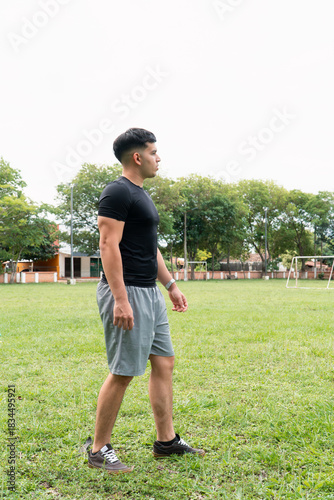 Strong man walking at the public park.