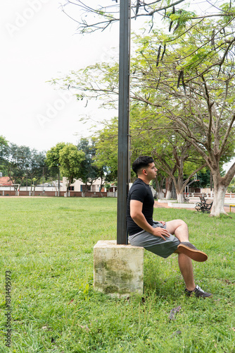 Man sitting with his legs crossed at the public park.