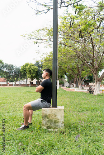 Thoughtfull man sitting, watching the view at the public park.