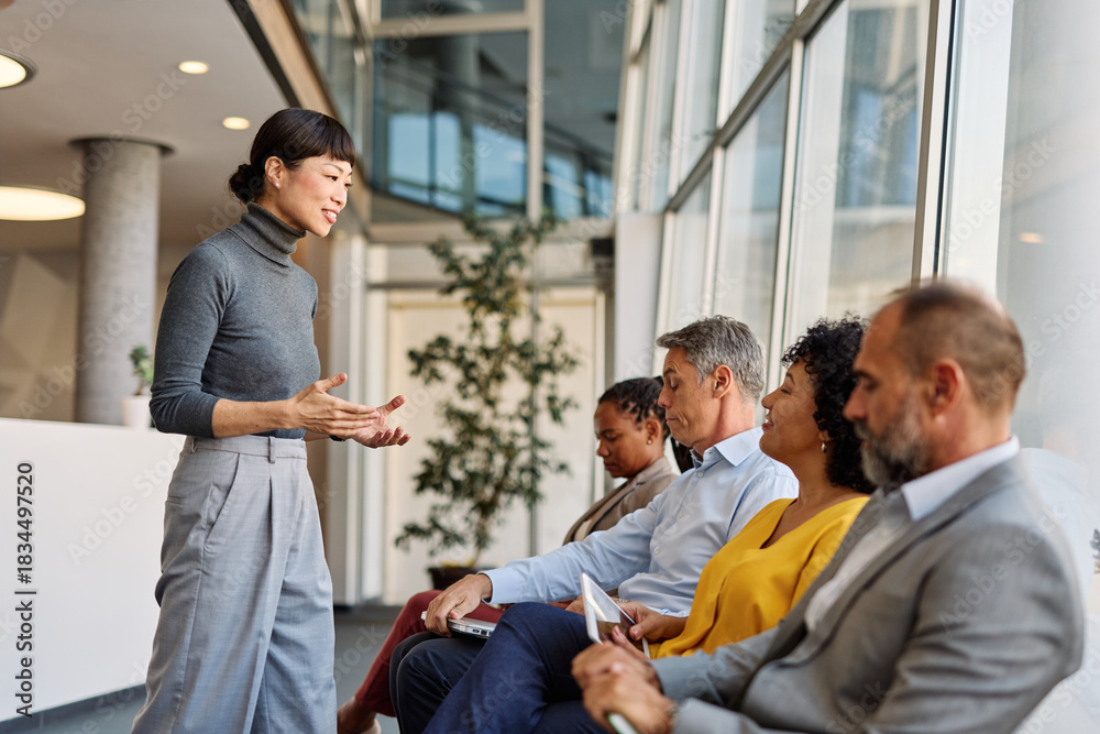 Fototapeta premium Portrait of a businesspeople sitting in chair and waiting for an interview for job application being congratulated by a businesswoman in office