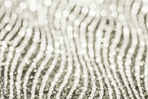 Abstract bokeh lights create a shimmering, wavy pattern, forming a dynamic and glowing background celebrating white and bright colors. Color of 2026 year dancer in the white cloud