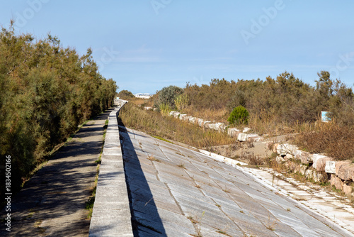 View of the Murazzi sea defenses on a sunny day on Pellestrina Island, Venice, Italy