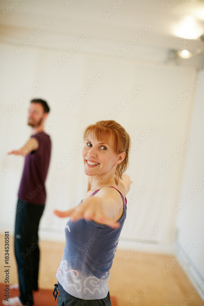 Obraz premium Woman, happy and portrait at yoga class for stretching arms, warm up and exercise together at club. Personal trainer, wellness and coach with confidence, circulation and holistic fitness at gym