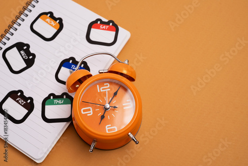 Alarm clock with day stickers. Time management and scheduling.