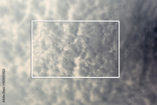 Template with frame for using the color of the year 2026 - Cloud Dancer. Fluffy white cumulus clouds against deep blue summer sky. Cloudscape view from airplane window.