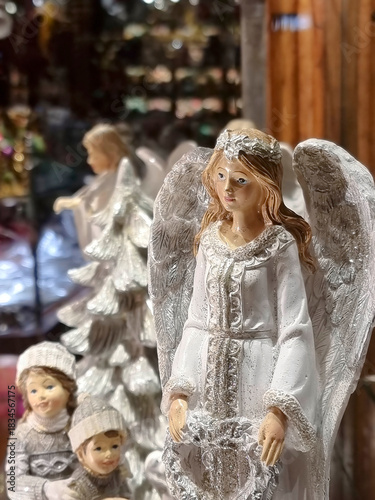 Beautiful white angels, Christmas decorations for sale on a shop window, decorative hand painted ornament in advent market