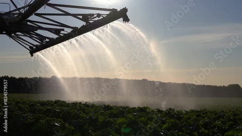 An agricultural sprayer applying water to a field, showing irrigation and crop care Stock Video