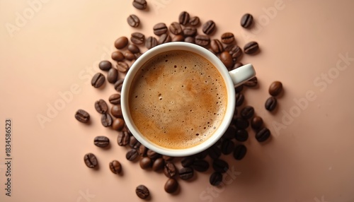 Overhead photo of a coffee cup surrounded by coffee beans. The warm drink sits on a light brown surface. Freshly brewed coffee with rich aroma is perfect for morning beverage.