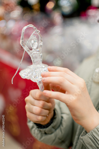 A girl in a store among Christmas decorations. Preparing for the New Year and Christmas. Buying decorations and gifts.