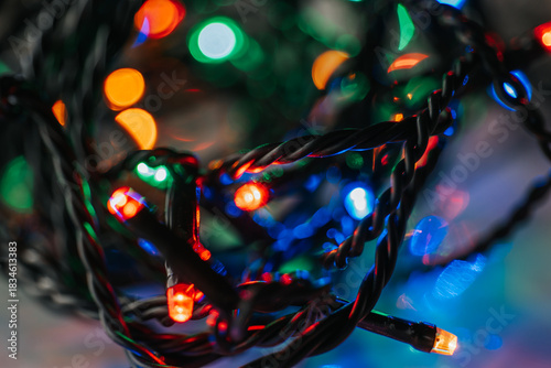 Tangled String of Christmas Lights. Christmas and New Year lighting. Festive atmospheric background with garlands. Garland light wallpaper.