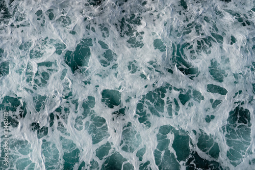Abstract texture of churning sea foam and turquoise ocean water, Cook Strait, NZ