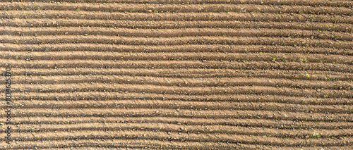 Horizontal Orientation Of Straight Furrows In A Cultivated Field Providing A Neat And Organized Background Image For Farming Topics