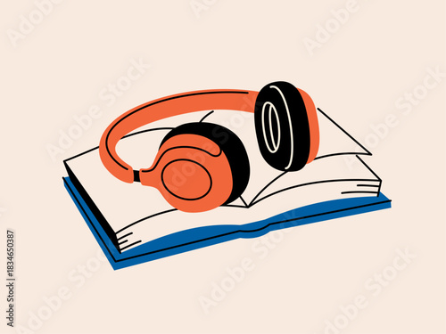 Headphones placed on top of a book