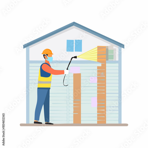 A sanitation worker in protective gear disinfects a building exterior with a sprayer, ensuring safety and cleanliness during a public health crisis.