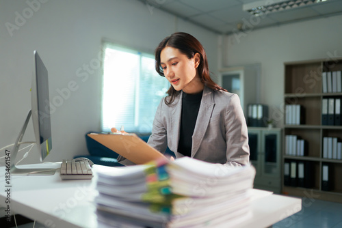 Female professional managing documents and paperwork in office