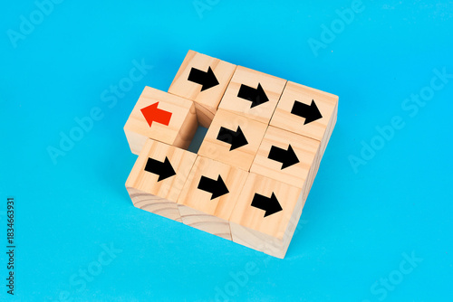 Slika na platnu A disruption and originality concept showing a single reversed arrow among aligned forward arrows to symbolize unique thinking and unconventional direction