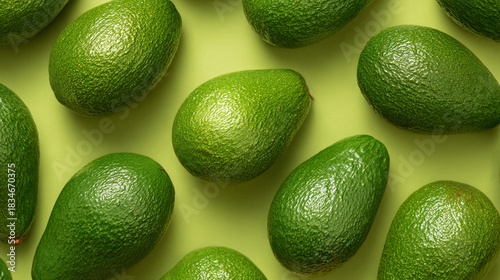 Healthy food concept. Monounsaturated fats, potassium, oleic acid, dietary fiber, nutrients. Ripped perfect avocados on green background.