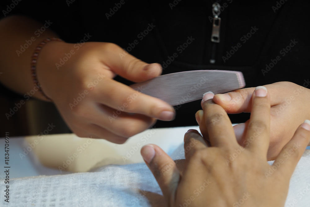 Obraz premium Nail care session at a beauty salon with careful attention