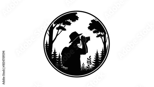 A black and white silhouette logo of a photographer in a hat and backpack, taking pictures amidst trees and nature, framed in a circular design.