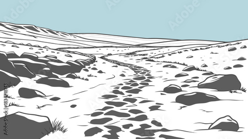 A landscape view of a rocky path leading into the distance with a light blue sky above the hills