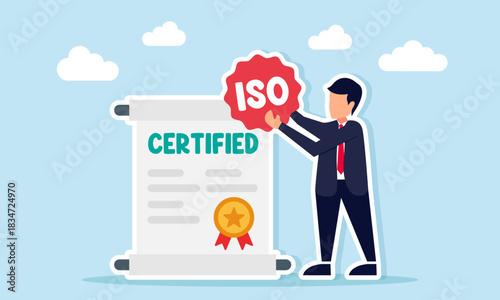 Businessman holding an ISO sticker near a certified document illustrating company success in achieving proper management certification