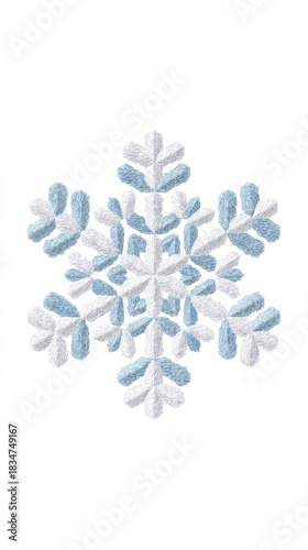 Intricate blue and white embroidered or knitted snowflake isolated on white background, winter holiday design element