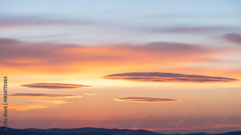 Fototapeta premium Lenticular Clouds at Sunset over Mountain Range, Orange and Purple Sky