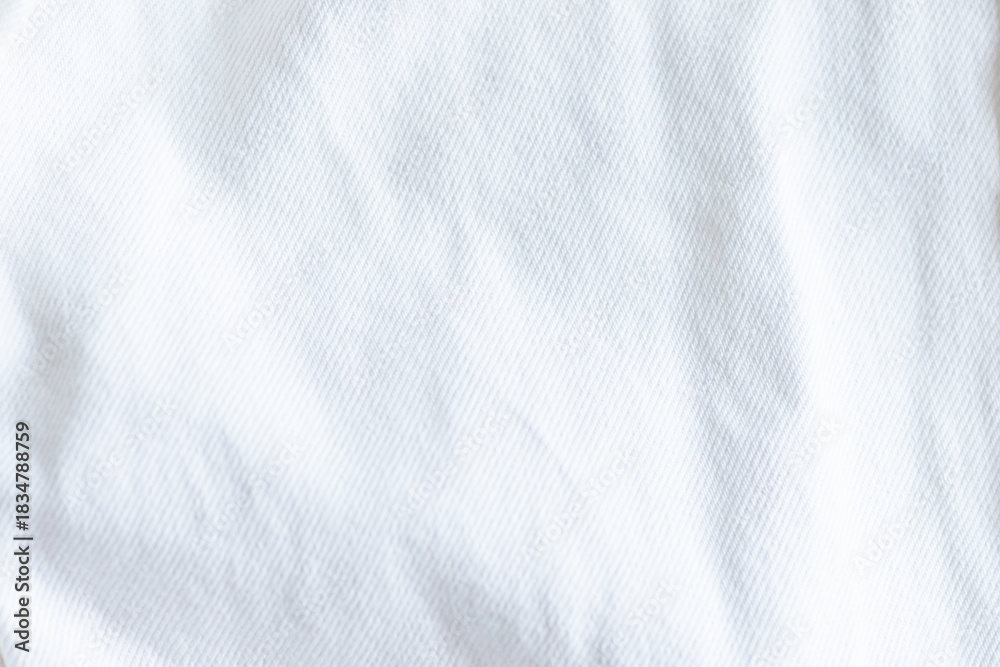 Fototapeta premium Close up of white fabric with subtle shadows and texture. Trendy color of 2026 year