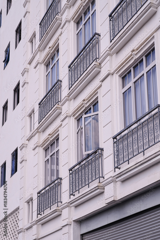 Fototapeta premium Elegant Hotel Facade with Classic Iron Balcony Railings