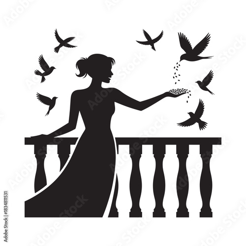 Silhouette of woman releasing birds from balcony