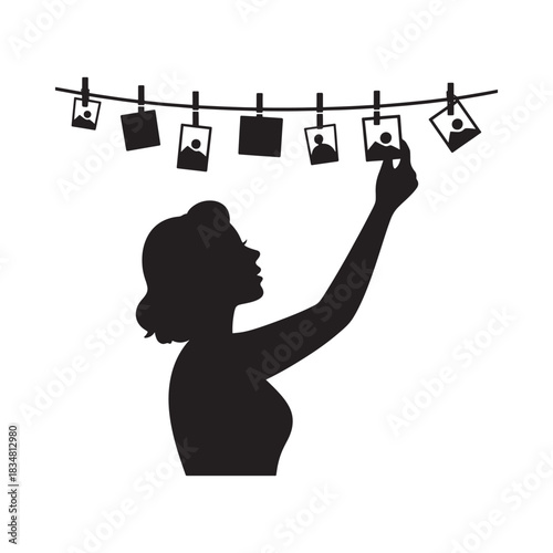 Woman hanging photos on a clothesline silhouette