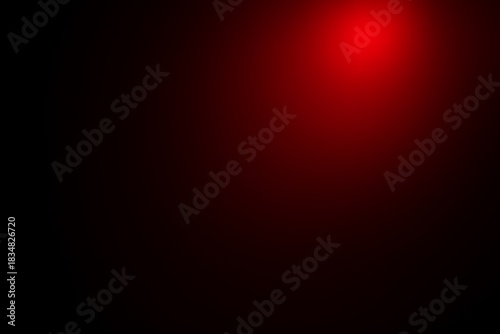 Abstract red spotlight effect on dark background with pixelated texture