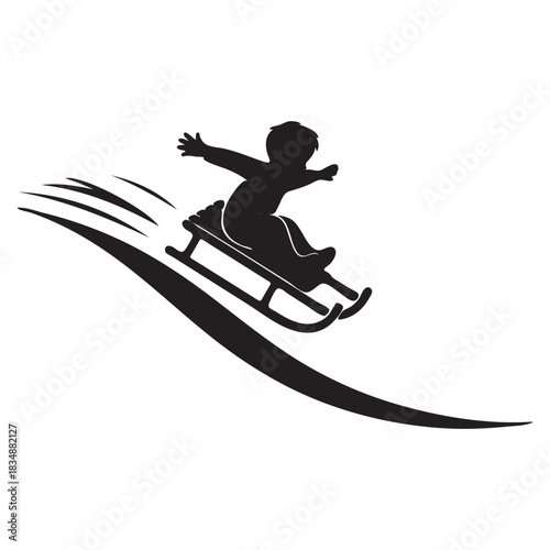 Silhouette of a child sledding down a snowy slope winter