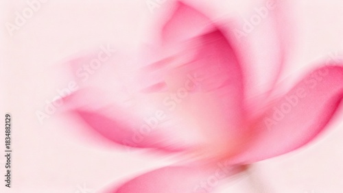 Blurred pink flower with soft petals against a light background
