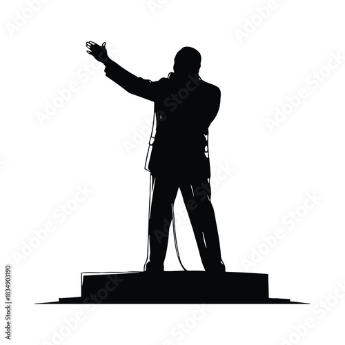 Silhouette of a man speaking into a microphone on a platform