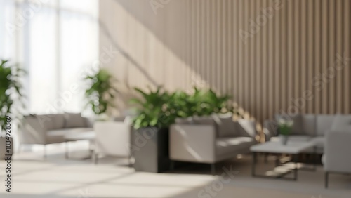 Abstract blurred background of a modern waiting area or hotel lobby, featuring contemporary furniture, green plants, and natural light.