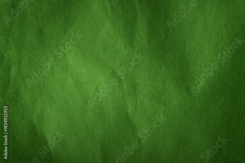 Dark leafy summer green tone color paint on recycled wrap creased paper texture background with space simple style