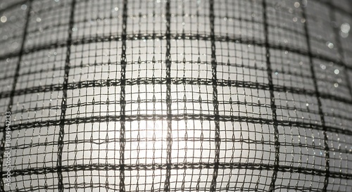 Translucent checkered fabric texture with bright light shining through.