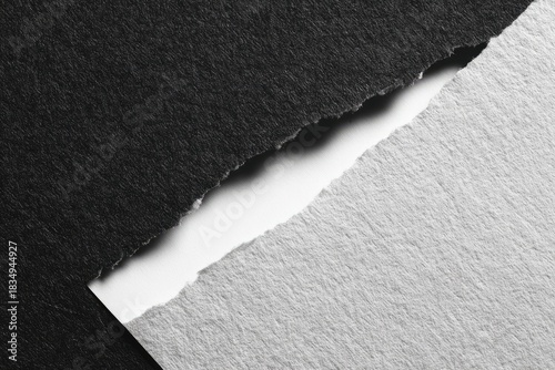 Torn paper shows dark/light contrasts, textured surfaces, and diagonal division line