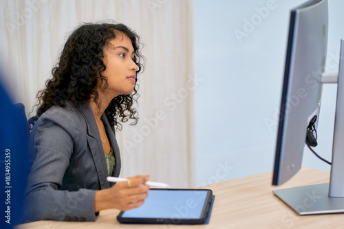 Mixed businesswoman look to monitor and will lecture on tablet while meeting with online session communication in co-working space.