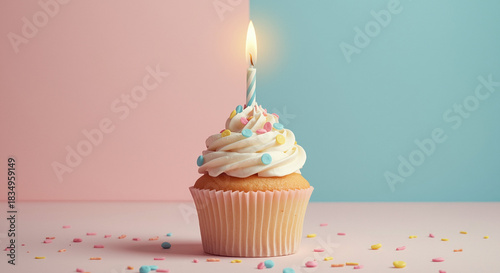  Pastel birthday cupcake with lit candle, colorful sprinkles and soft pink blue background for celebration greeting card or party invitation