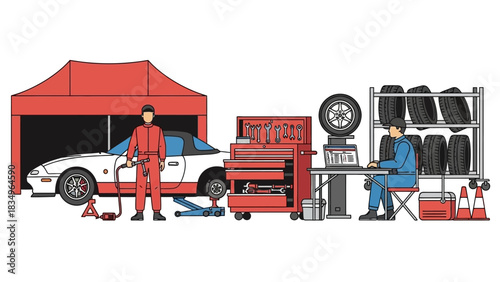 Auto mechanic works at a race car event in a garage checking diagnostics with his laptop